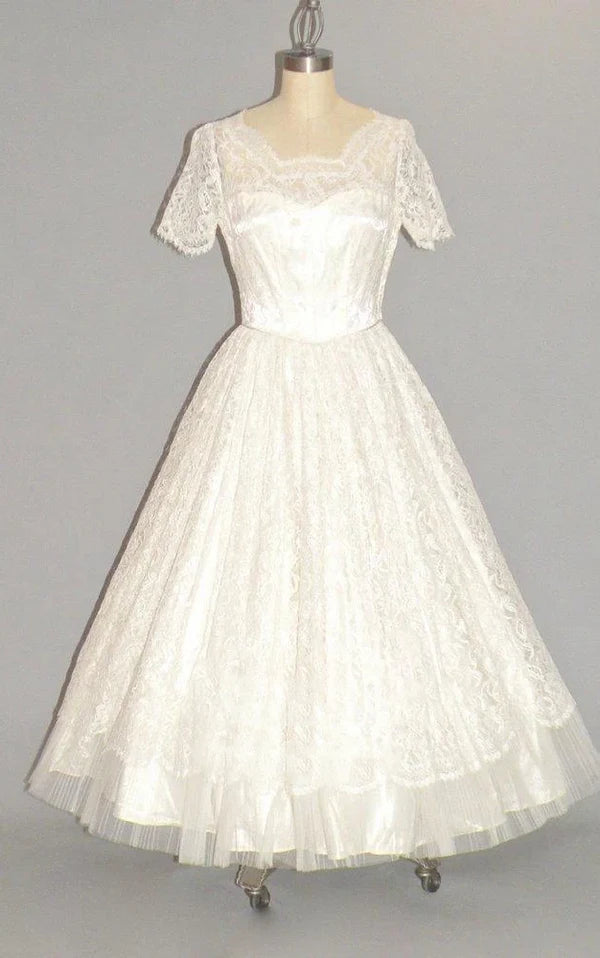 Side profile of a bride in a V-neck tulle and lace bridal gown.