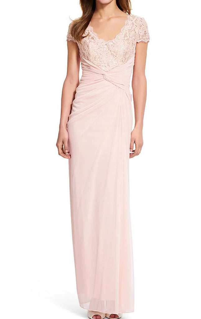 Woman wearing an elegant V-neck sleeveless lace chiffon Mother of the Bride gown.