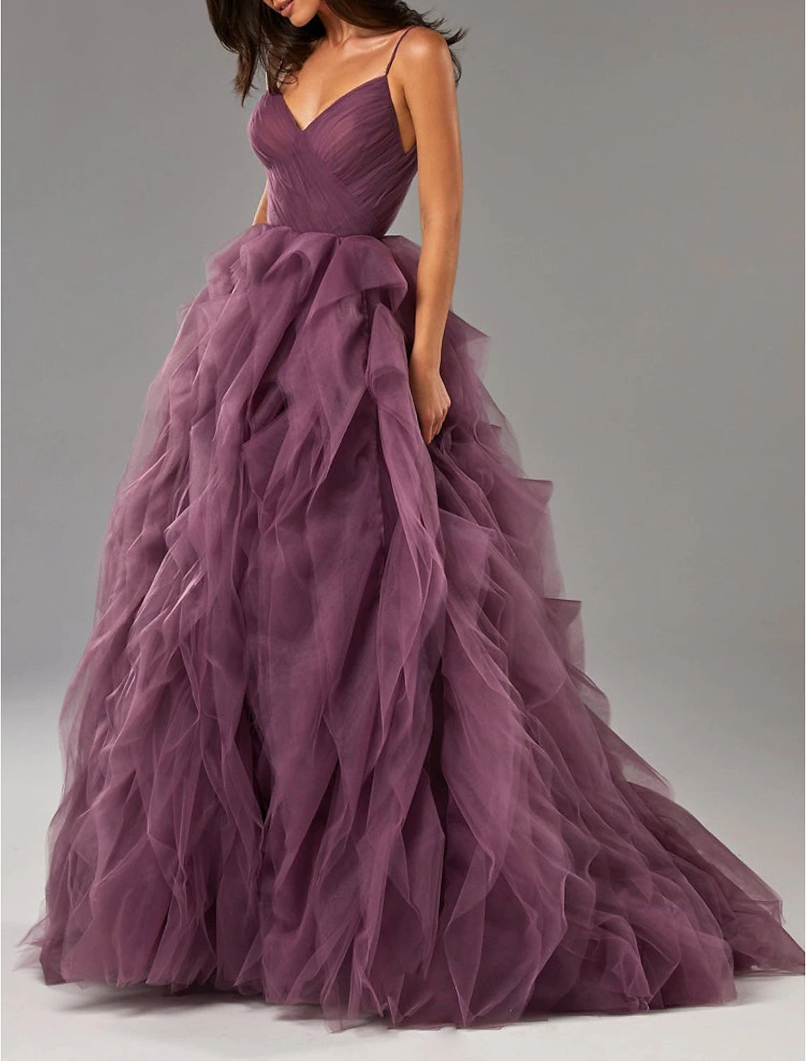 Side view of the tulle ball gown showing ruffles and sweep train.