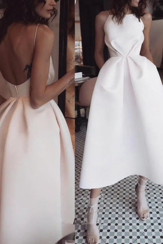Elegant tea length satin prom dress with spaghetti straps and a backless design.