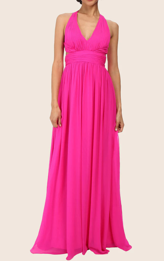 Woman in an elegant blush V-neck spaghetti strap chiffon maxi prom dress.