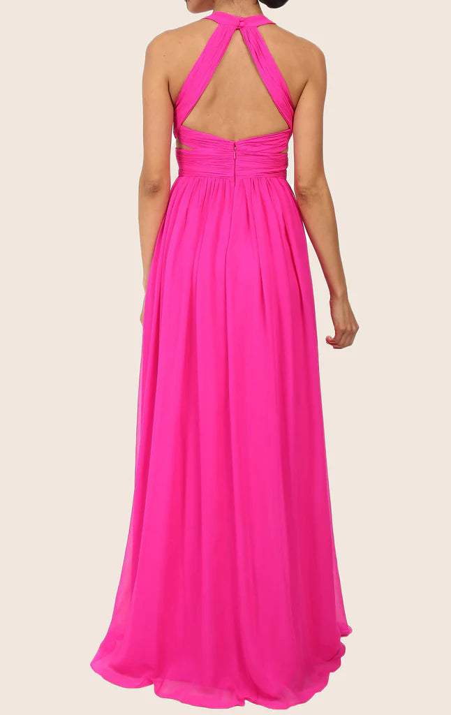 Back view of a woman in a blush V-neck spaghetti strap chiffon formal gown.