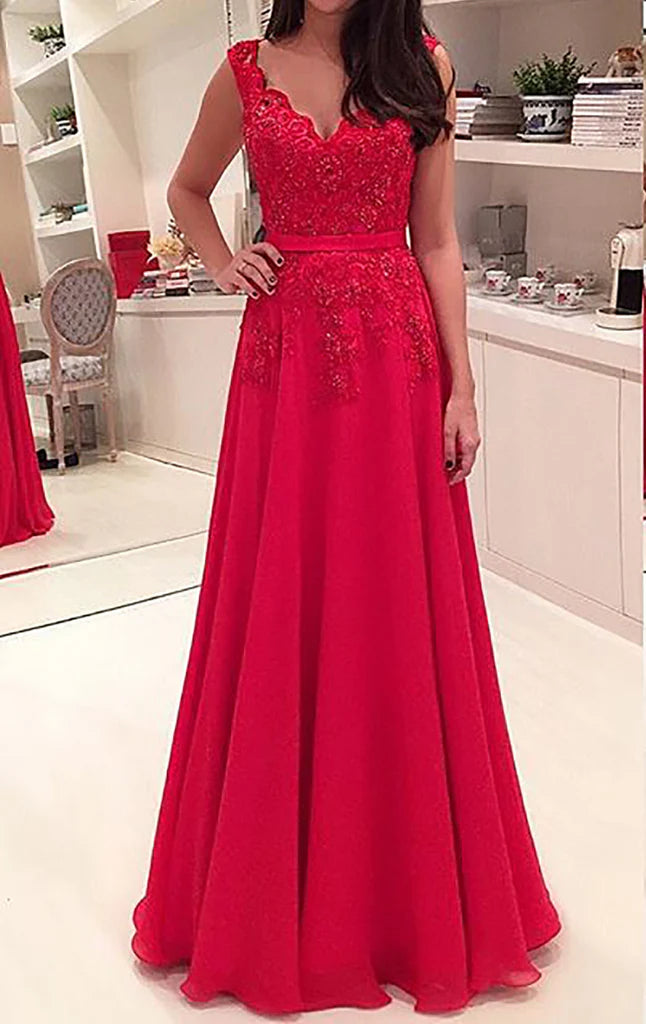 Elegant V-neck spaghetti strap prom gown with lace bodice and flowing chiffon skirt, shown on a model.