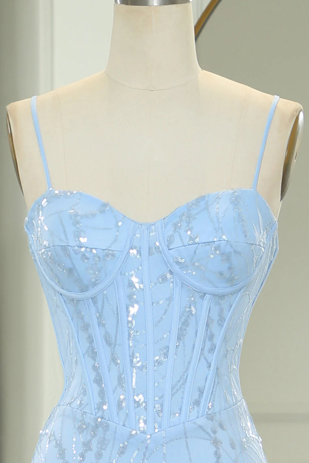 Close-up of the intricate sequined appliques on the light blue mermaid prom dress fabric.