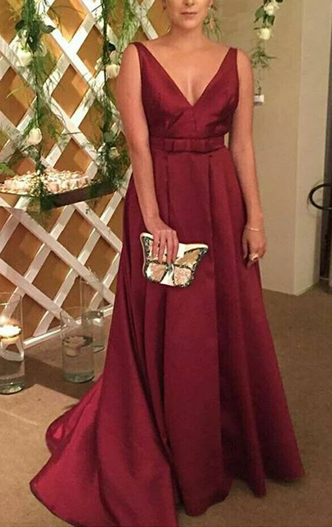Woman wearing an elegant V-neck spaghetti strap maxi prom dress.