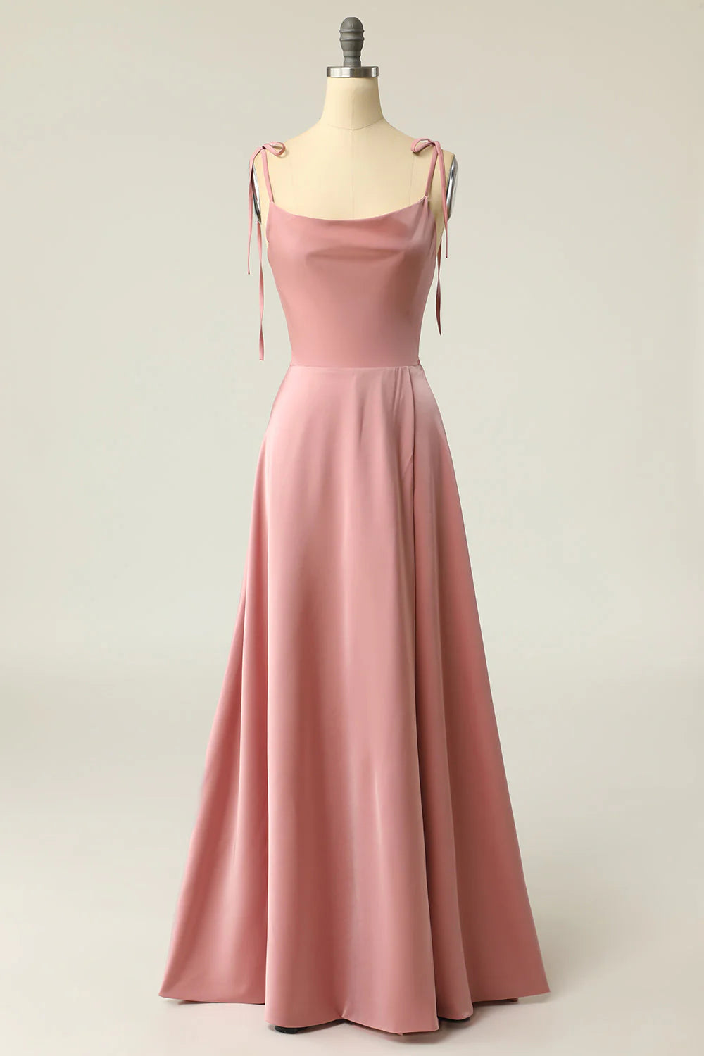 Woman wearing an elegant V-neck spaghetti strap prom dress with a bowknot detail.