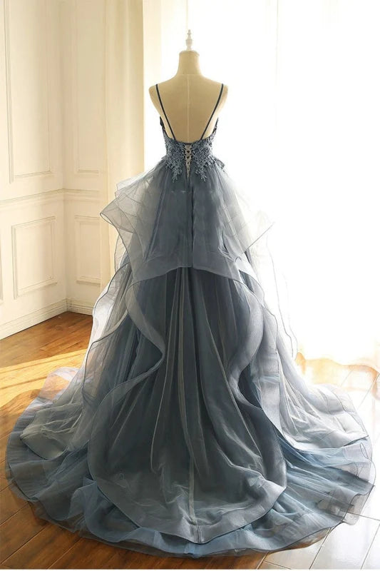 Back view of a flowy A-line prom dress with delicate ruffles.
