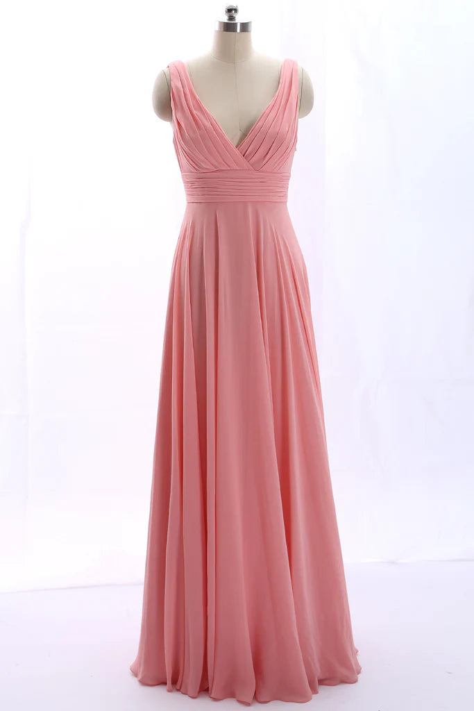 Elegant peach chiffon prom dress with V-neck, delicate straps, and a flowing skirt.