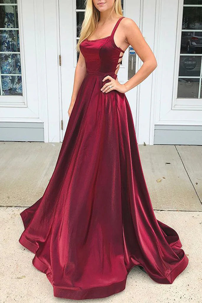 Woman wearing an elegant V-neck satin A-line long formal gown.