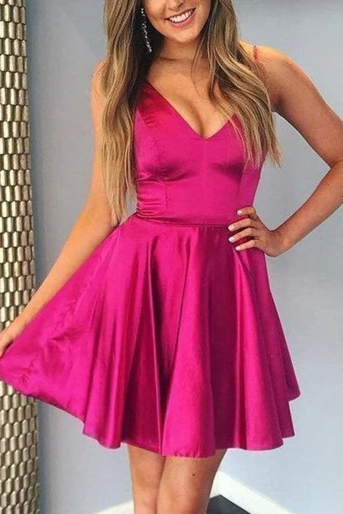 Woman posing in an elegant V-neck satin maxi dress with spaghetti straps.