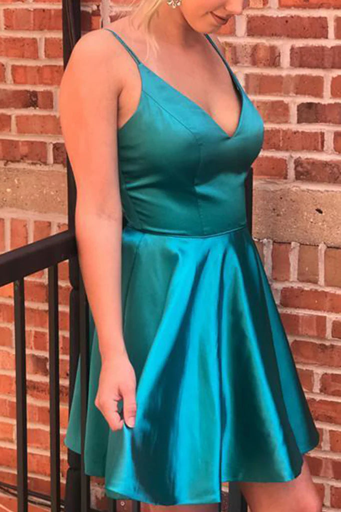 Back view of a woman in a V-neck satin formal gown.