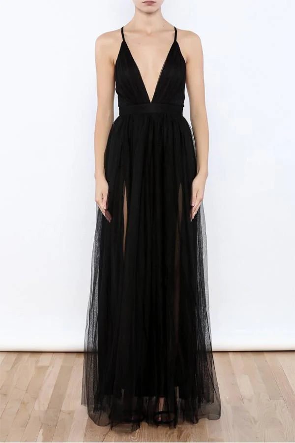 Woman wearing an elegant V-neck tulle evening gown with a high side slit.