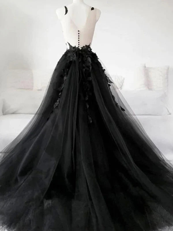 Close-up of intricate lace appliques on a tulle prom dress.