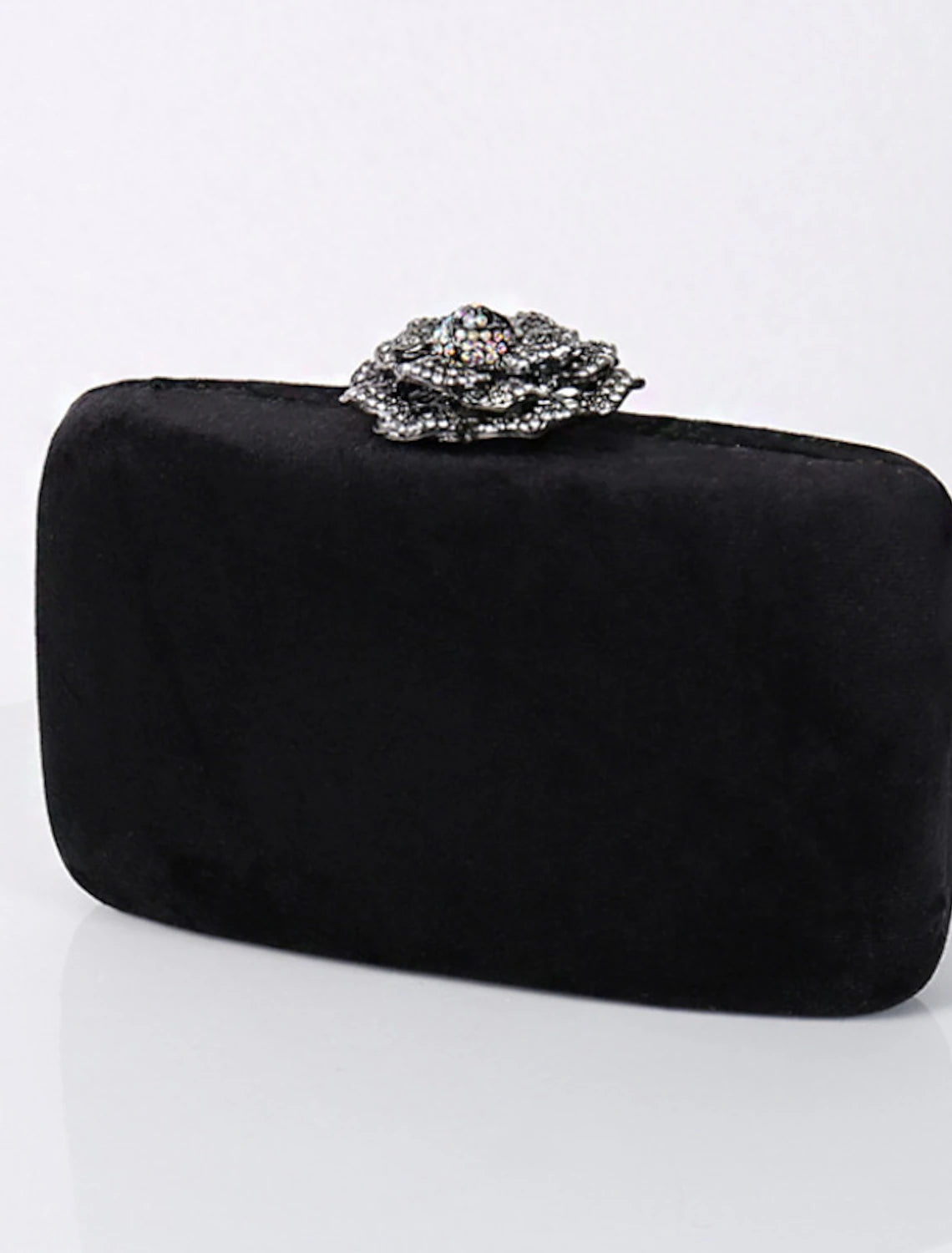 Side profile of the velvet clutch bag, showcasing its sleek design.