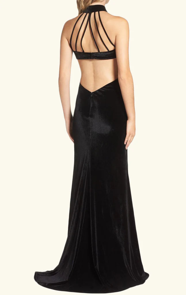 Back view of a woman in a velvet mermaid high neck long sleeve dress.
