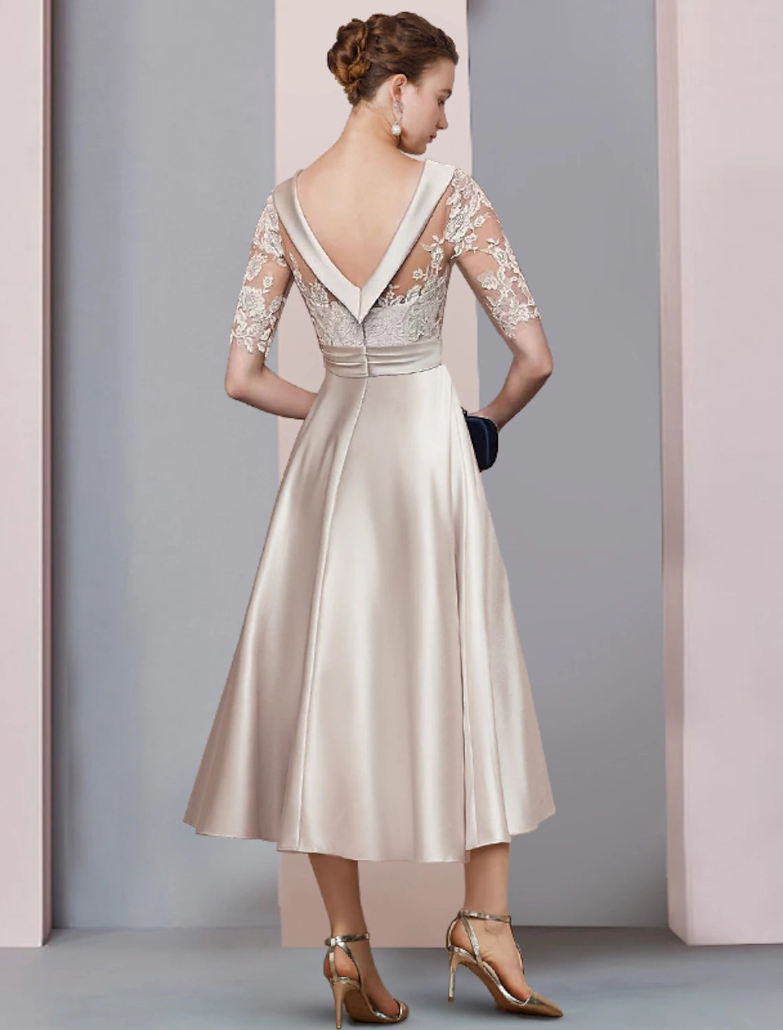 Vintage-inspired tea length gown with ruched appliques and delicate lace details.