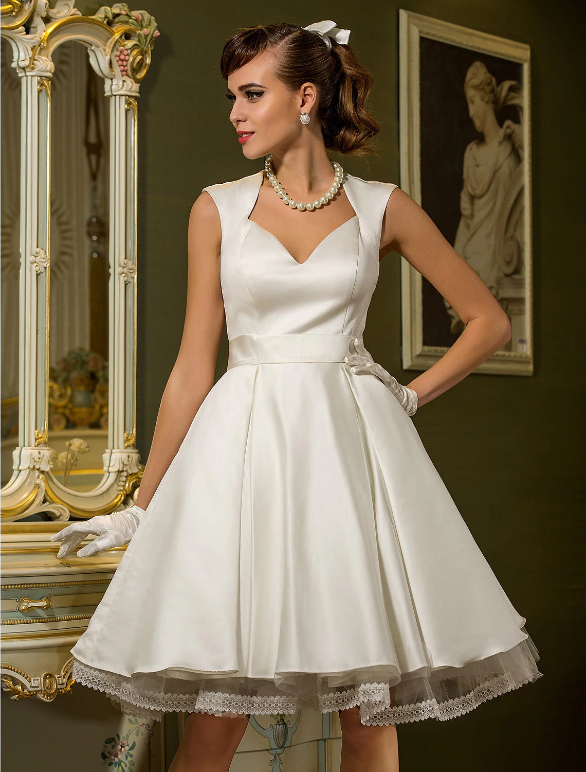 Front view of an elegant vintage A-line white satin wedding dress with sweetheart neckline and cap sleeves.