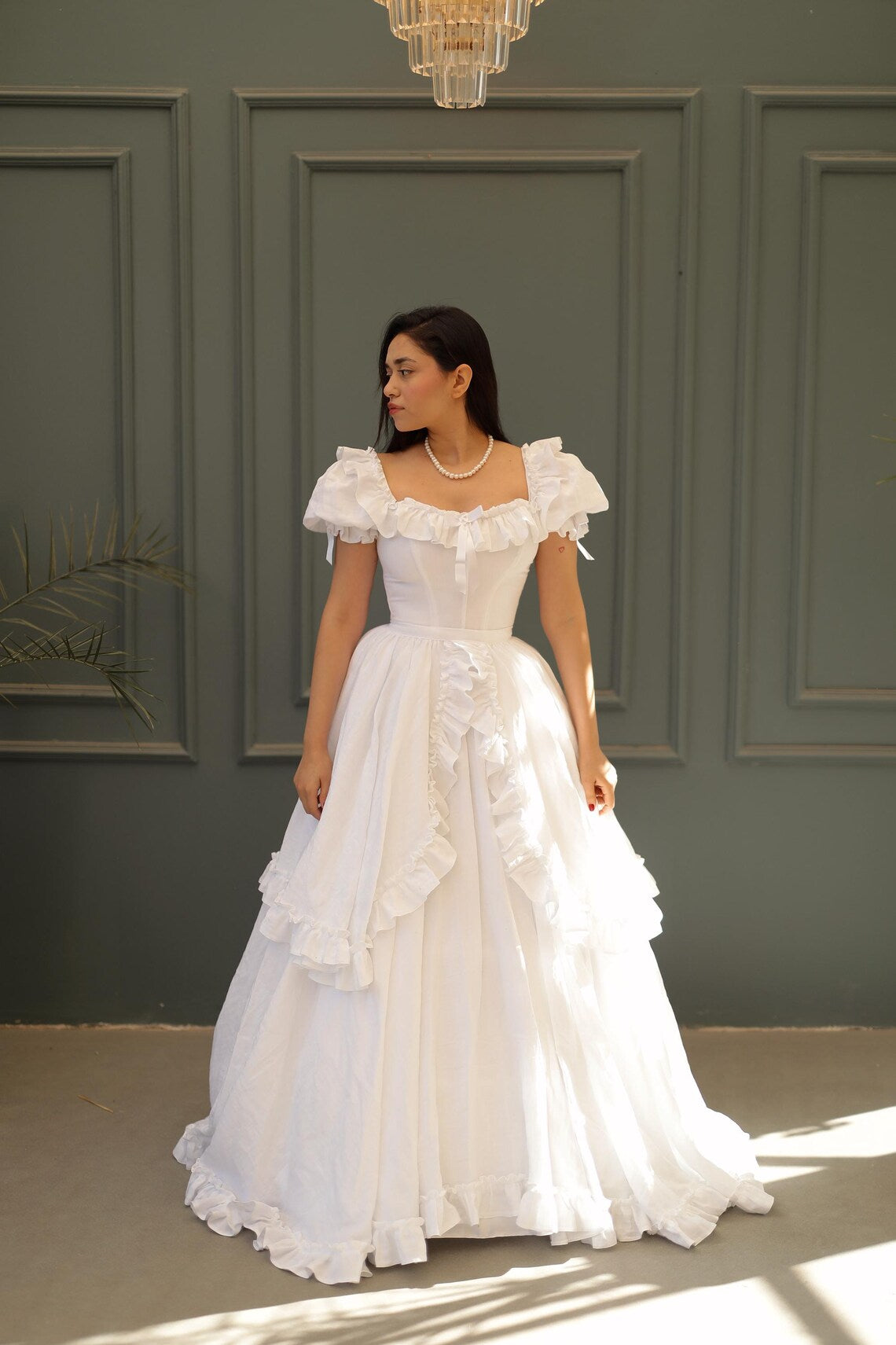 Back view of the white vintage dress, highlighting the detachable cape detail.