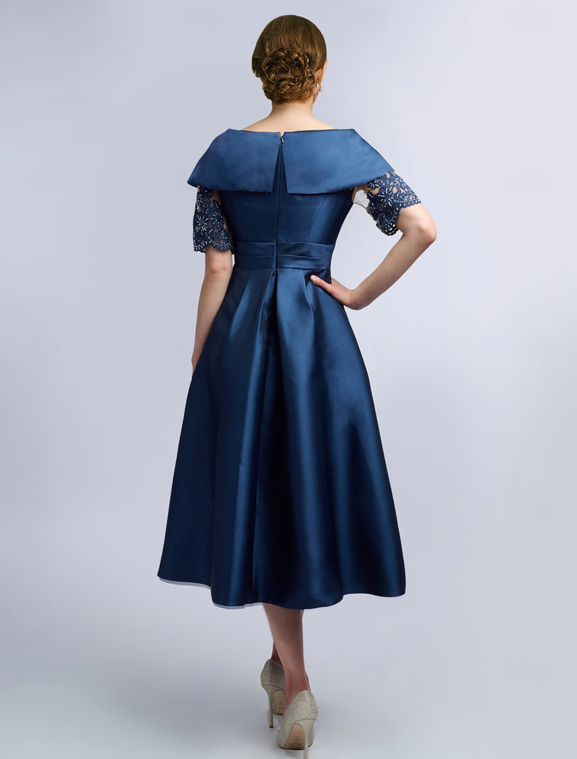 Back view of the elegant satin tea length dress with criss-cross lace.