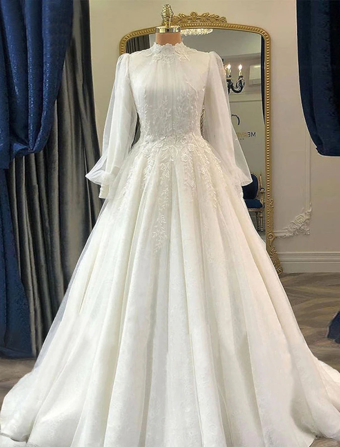 Elegant vintage ball gown wedding dress with high neck, long lace sleeves, and court train.