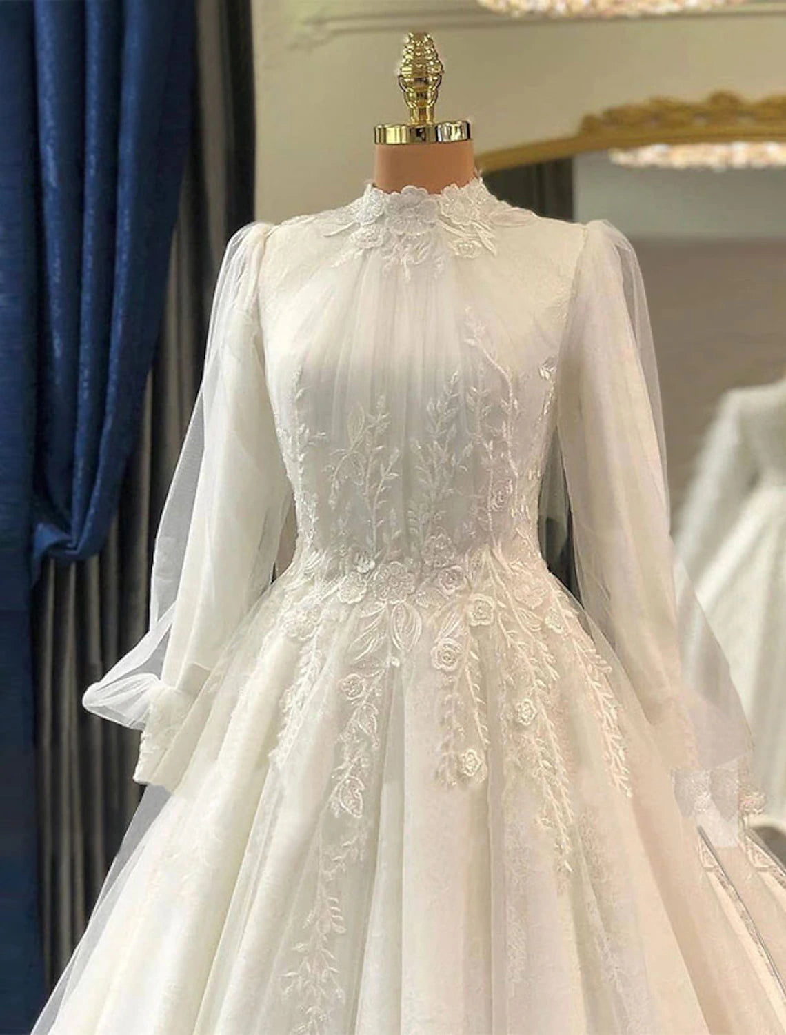 Back view of a vintage high neck lace wedding dress showing the court train and pleats.