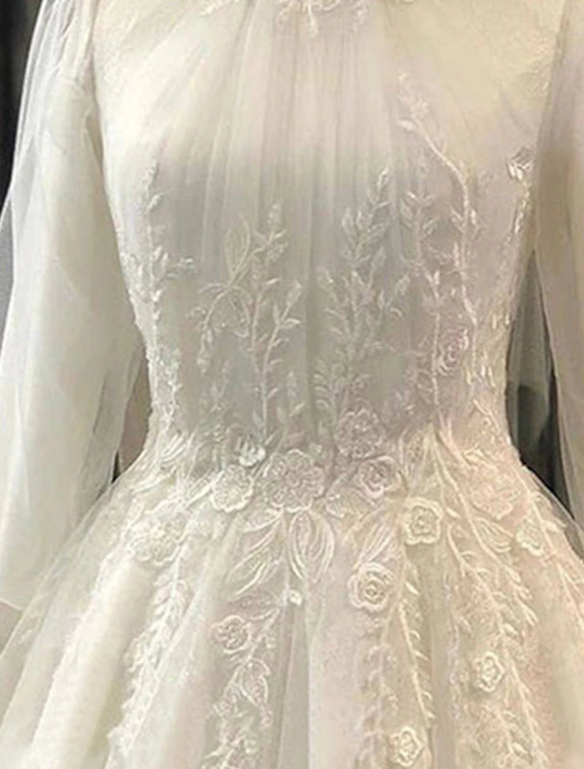 Side profile of the vintage-inspired wedding dress highlighting the ball gown silhouette.