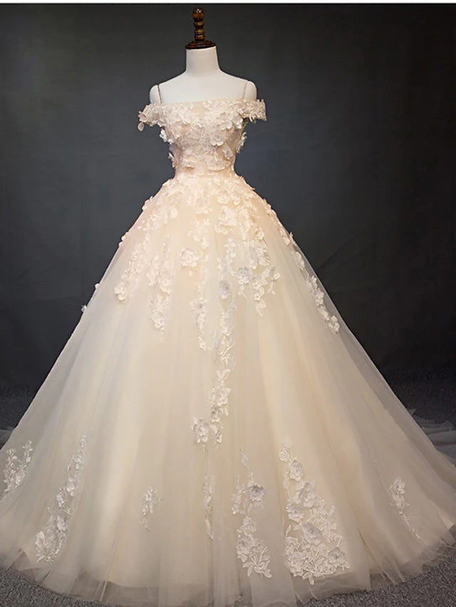 Vintage off-shoulder ball gown wedding dress with lace and pearl appliques.