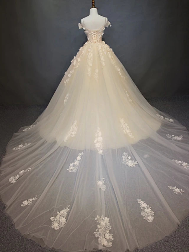 Back view of a vintage wedding dress with cathedral train and lace details.