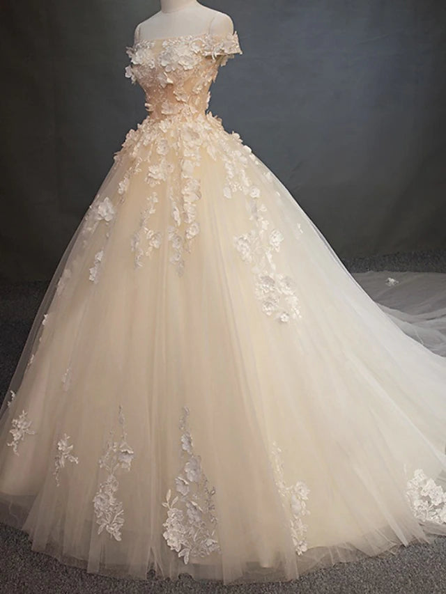 Full view of a vintage ball gown wedding dress with a long train.