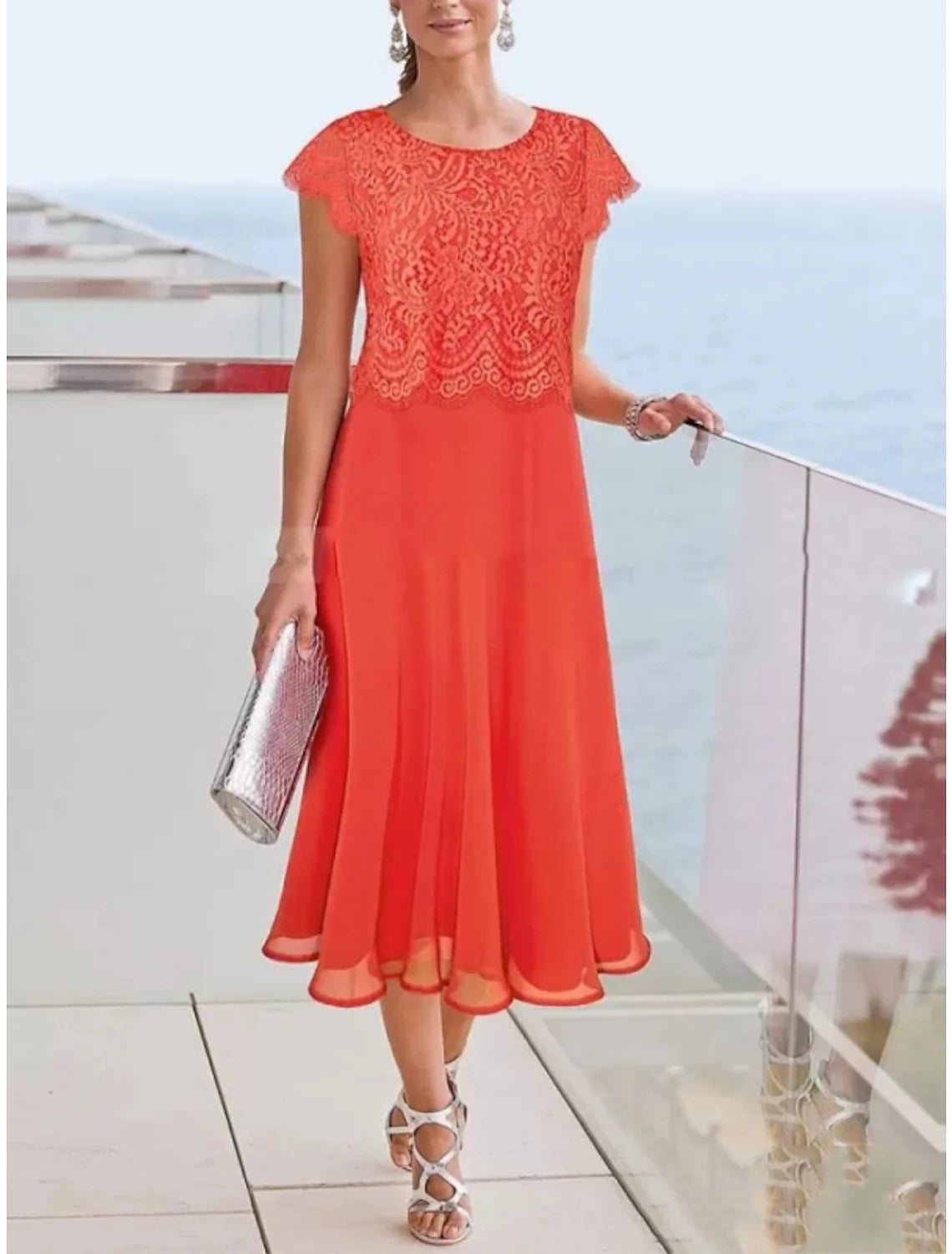 Back view of an elegant tea length sheath dress, featuring pleats and a solid color.