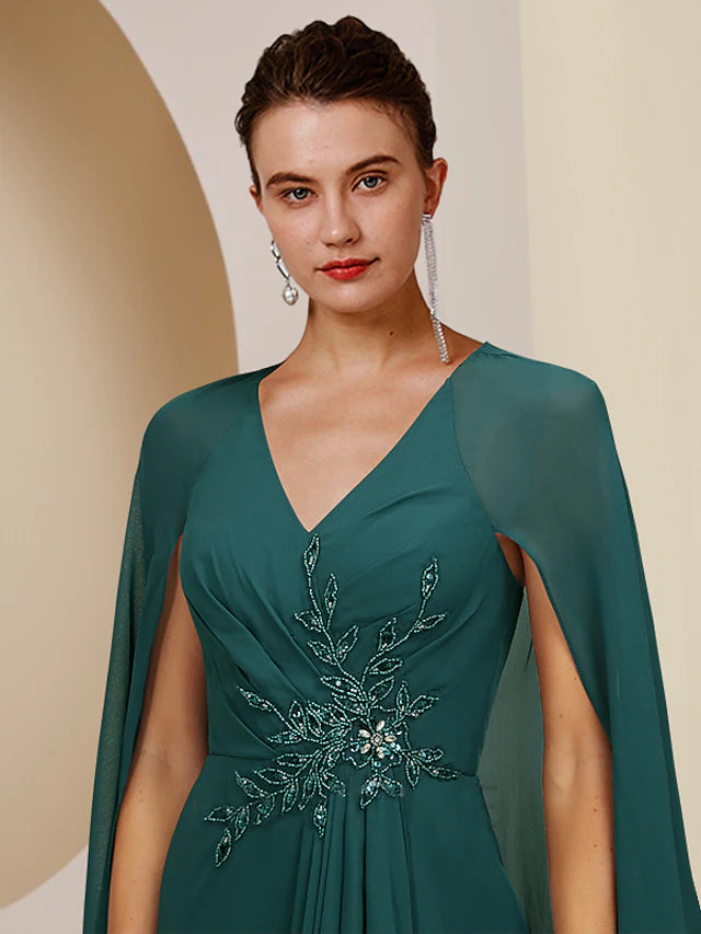 Sheath style knee-length dress in chiffon with V-neck and crystal details.