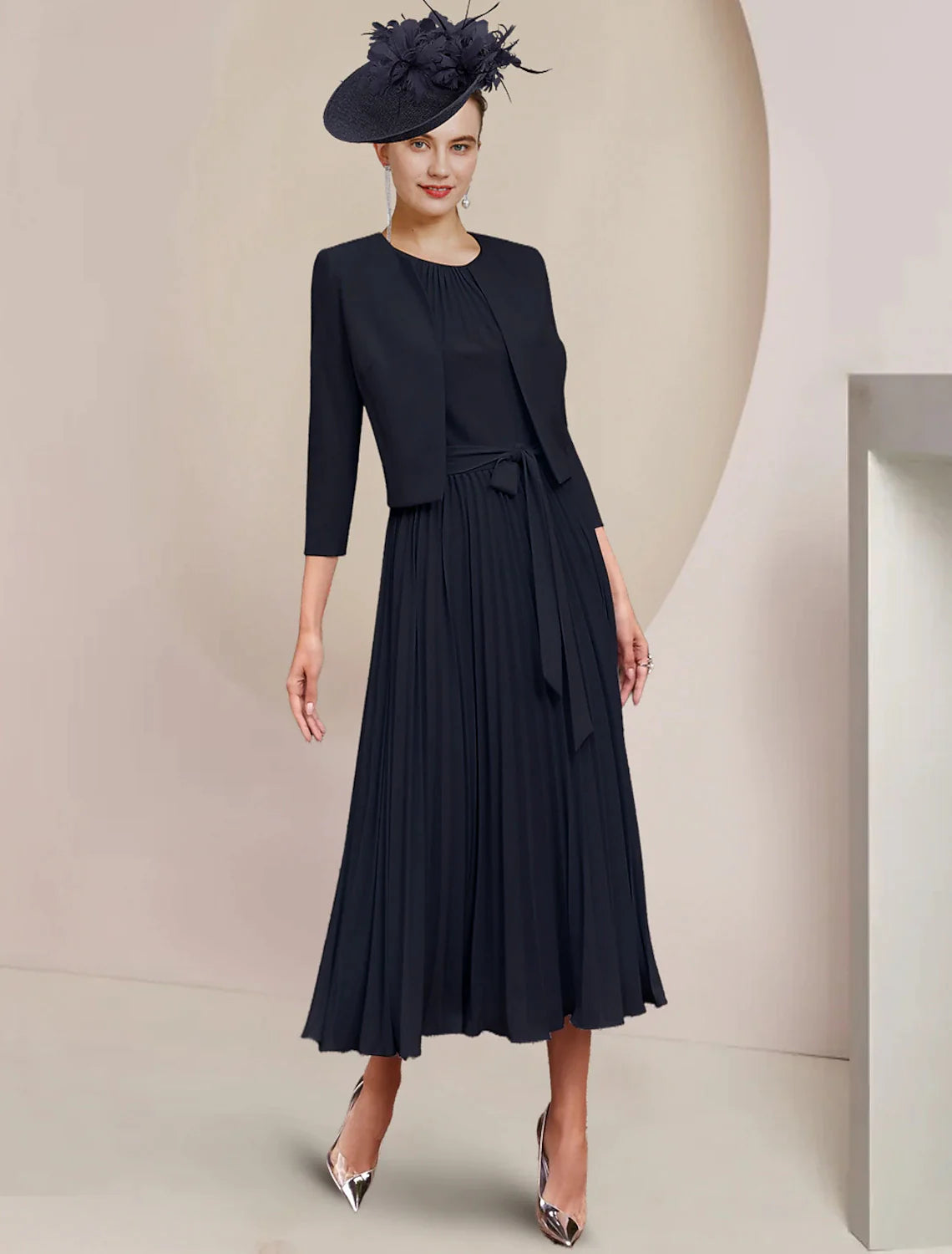 Back view of the two-piece A-line tea length dress, showing pleats.