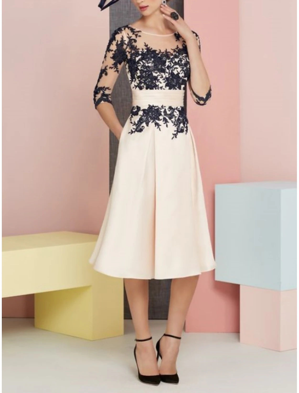 Model wearing an elegant vintage two-piece satin lace knee-length dress with a scoop neck and half sleeves.