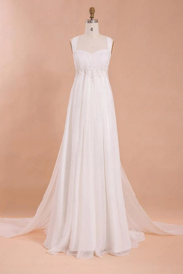 Woman in a white A-line halter chiffon beach wedding dress.