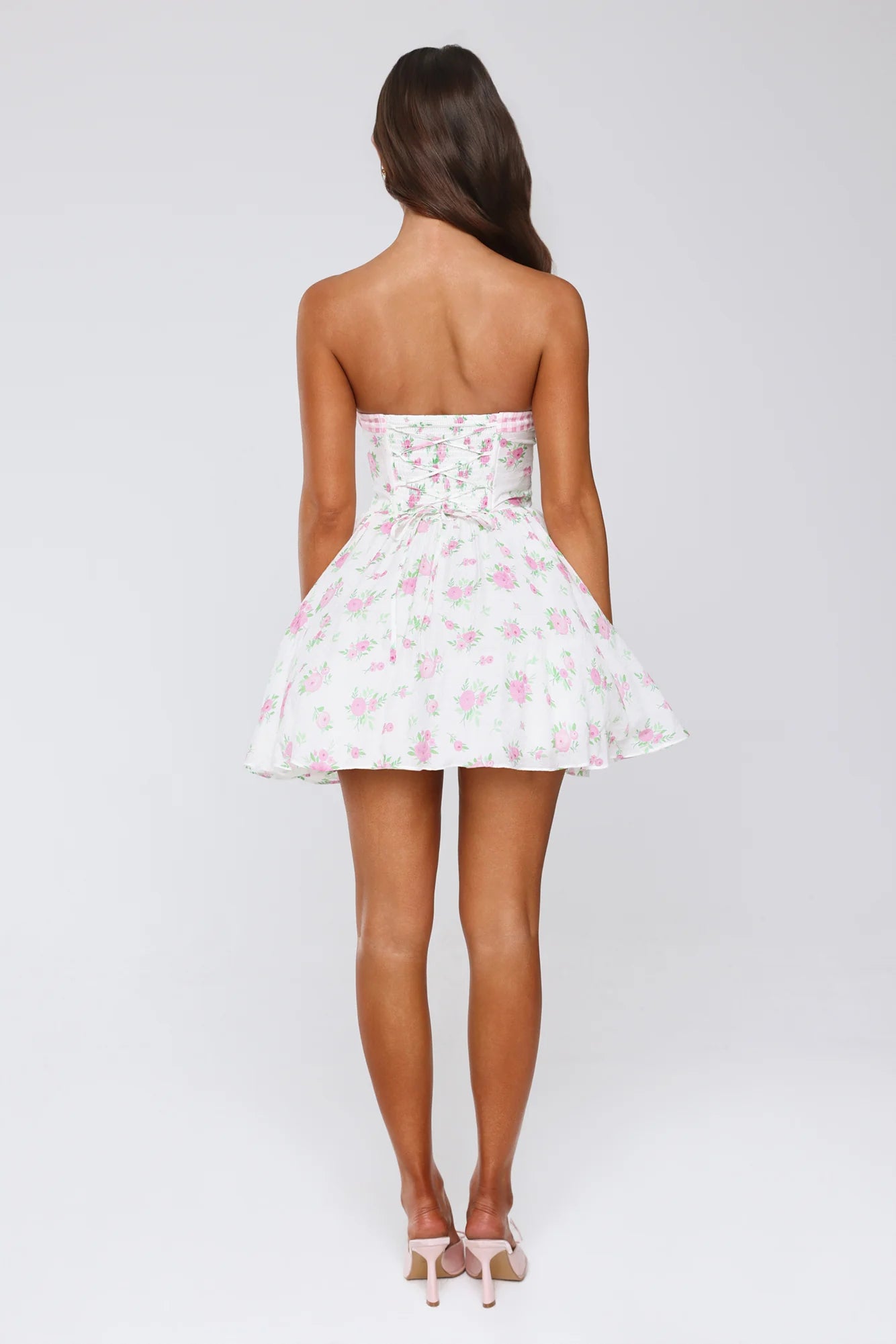 Back view of white floral strapless dress showing corset lacing.