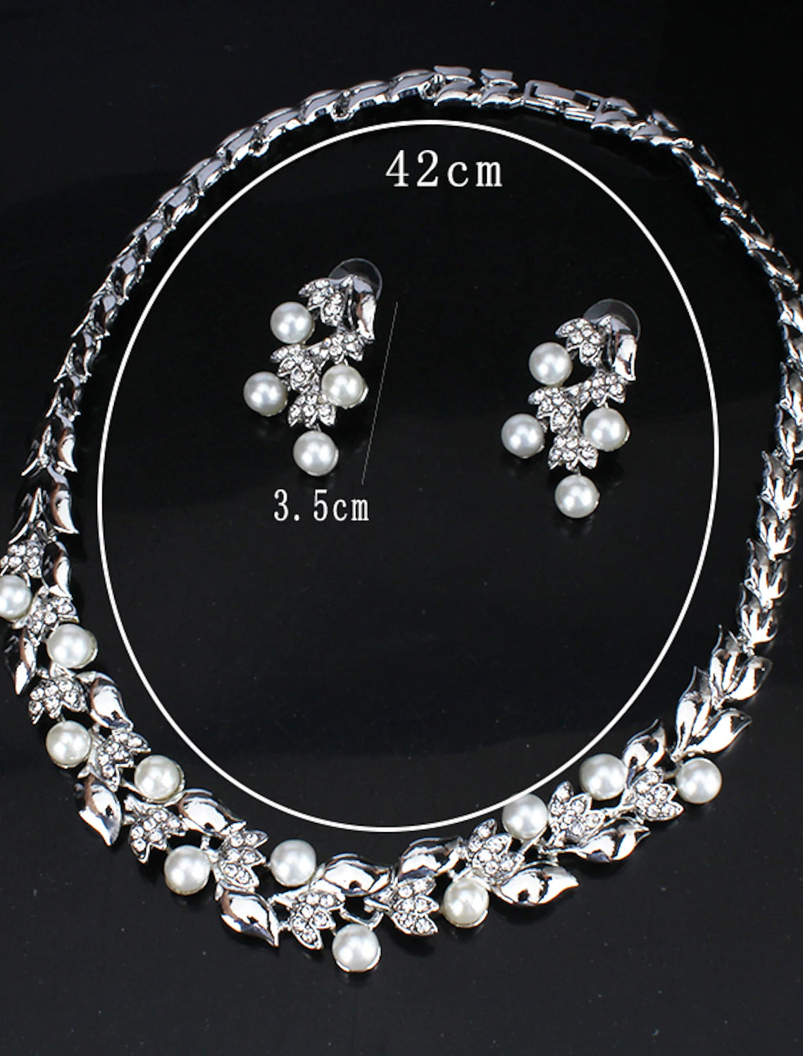 Close-up of the elegant white imitation pearl and rhinestone leaf necklace.