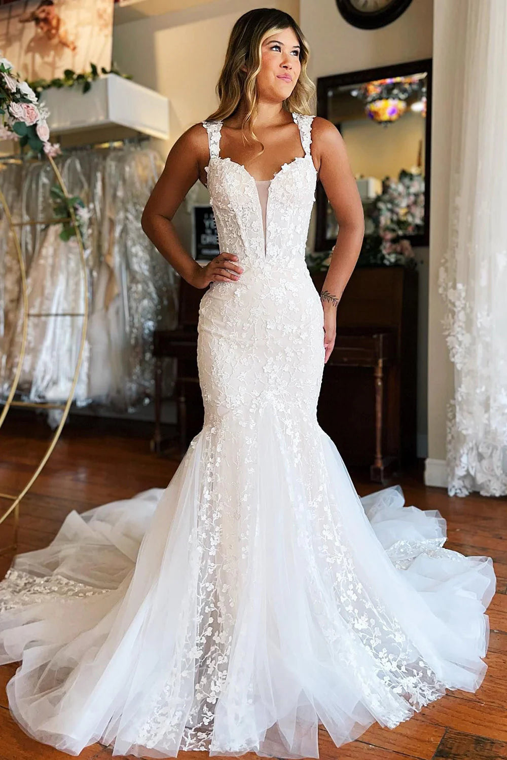 Elegant white mermaid lace wedding dress with a sweep train.