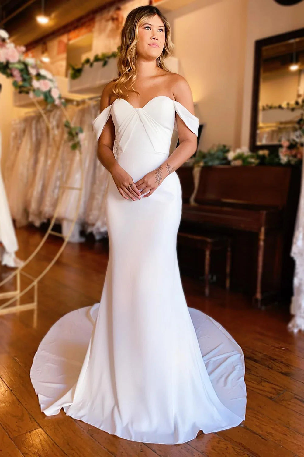 White mermaid off-shoulder boho wedding dress, front view.