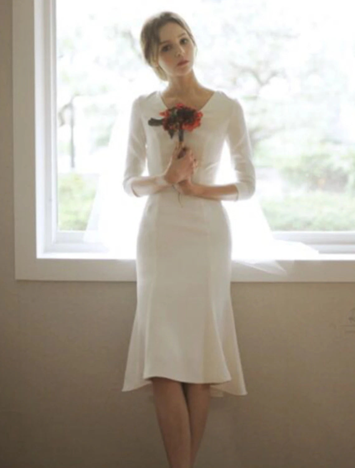 Elegant white mermaid reception wedding dress with V-neck and 3/4 sleeves.