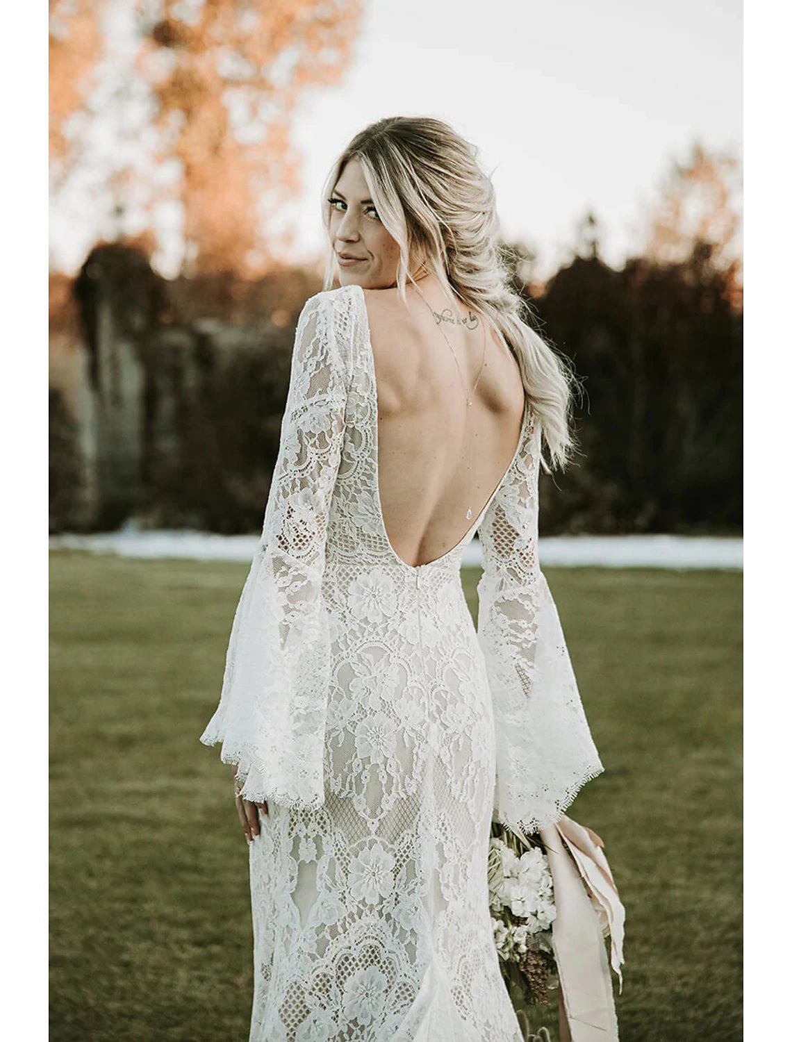 Close-up of the lace appliques on the long sleeve and bodice of the wedding dress.