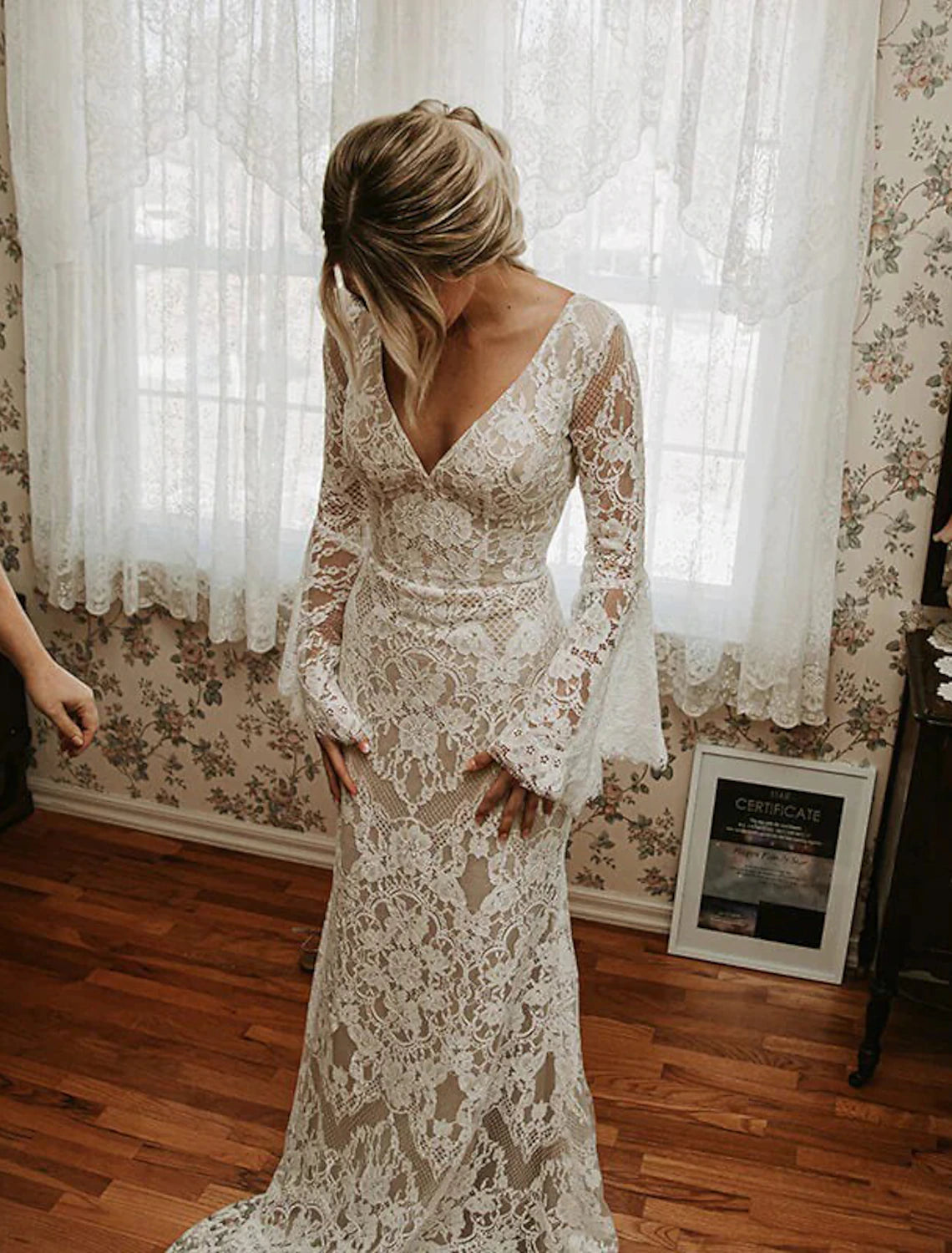 Detailed view of the lace pattern and fabric texture on the bridal gown.