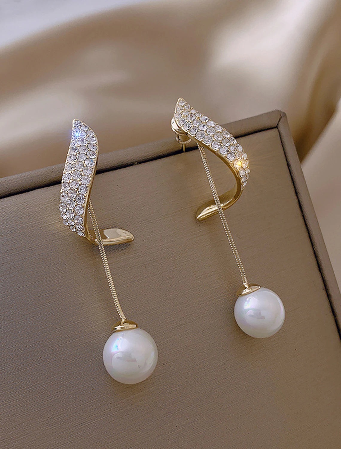 Elegant white pearl drop earrings.