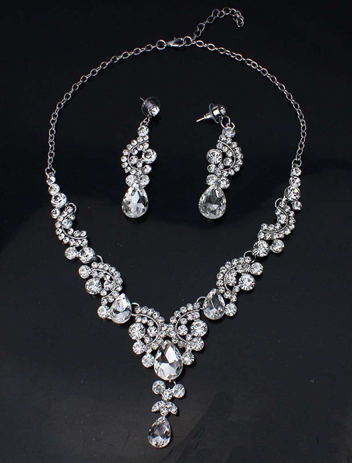 Detailed view of white rhinestone hoop earrings.