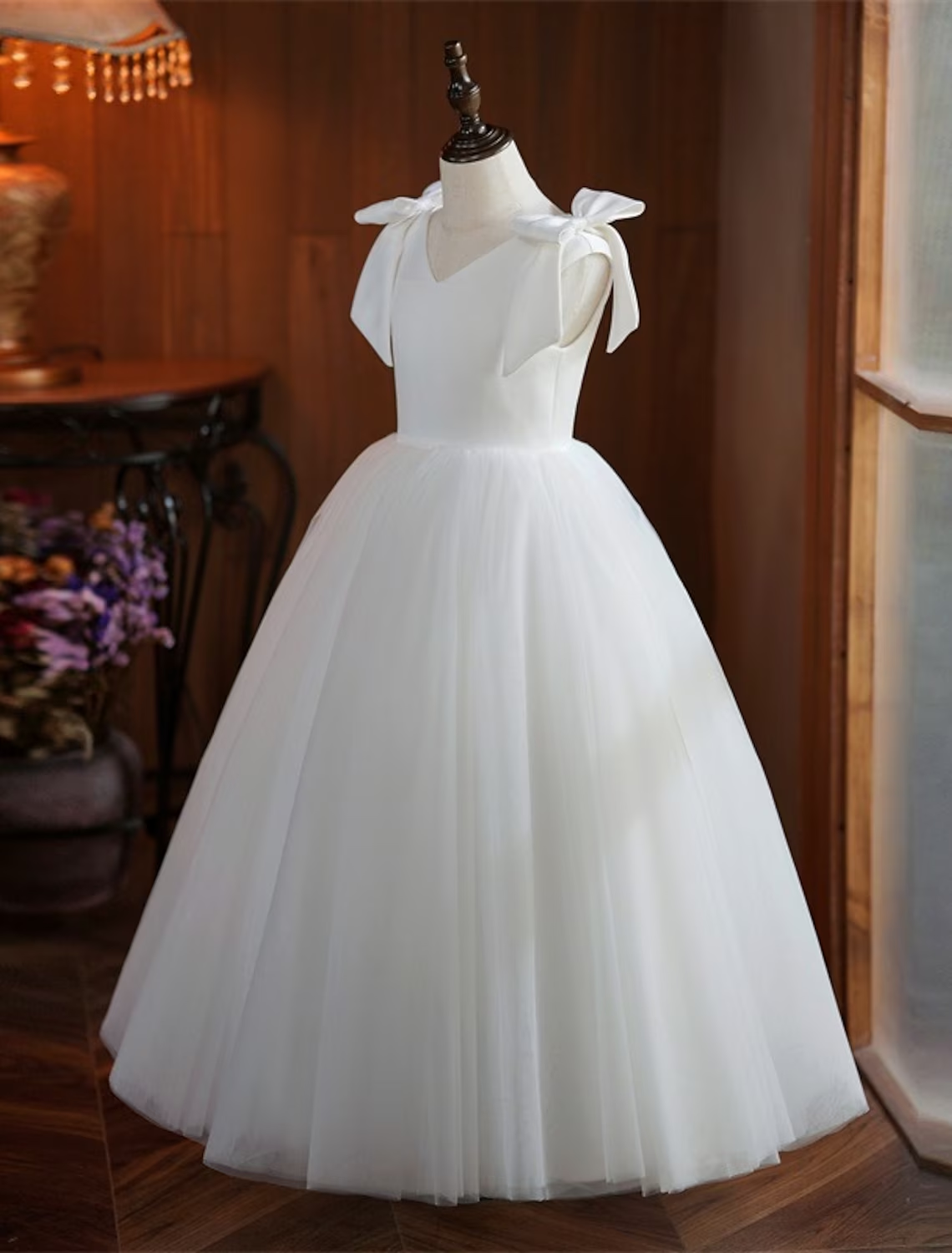 Girl posing in an elegant white party dress.