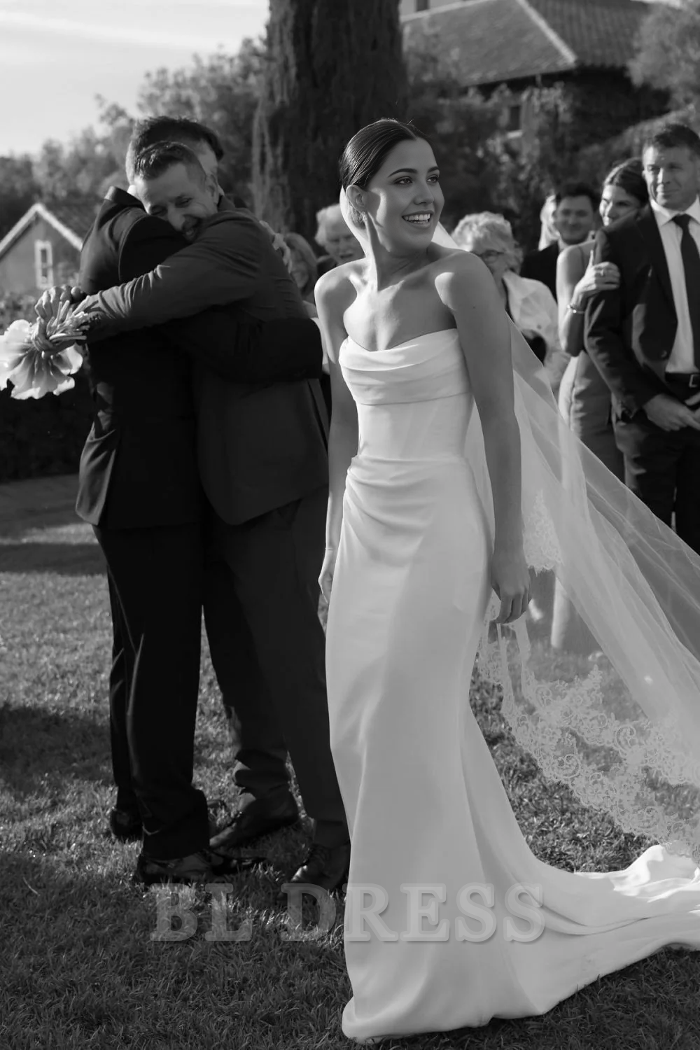 Model wearing an elegant white strapless corset mermaid wedding dress.