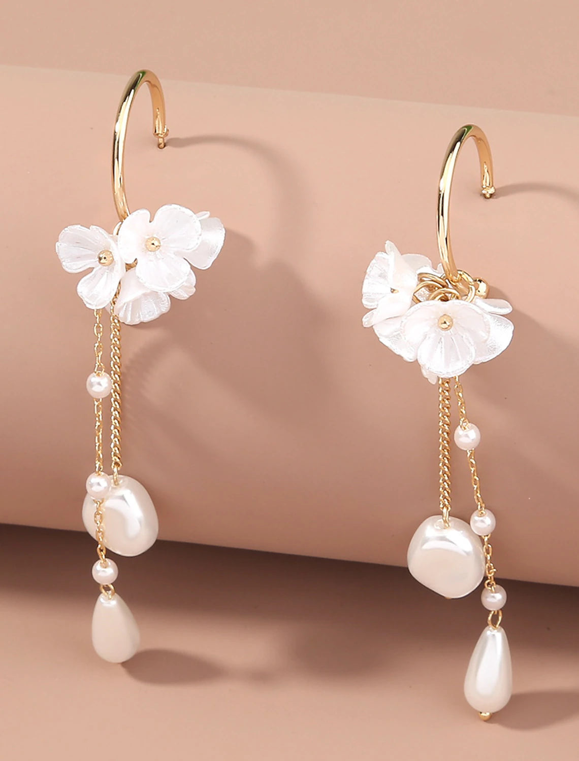 Model wearing white tassel fringe flower earrings.