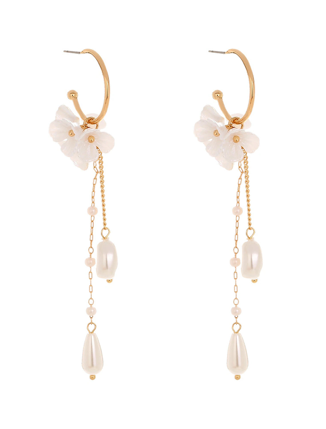 Detailed view of white flower-shaped earring with tassels.
