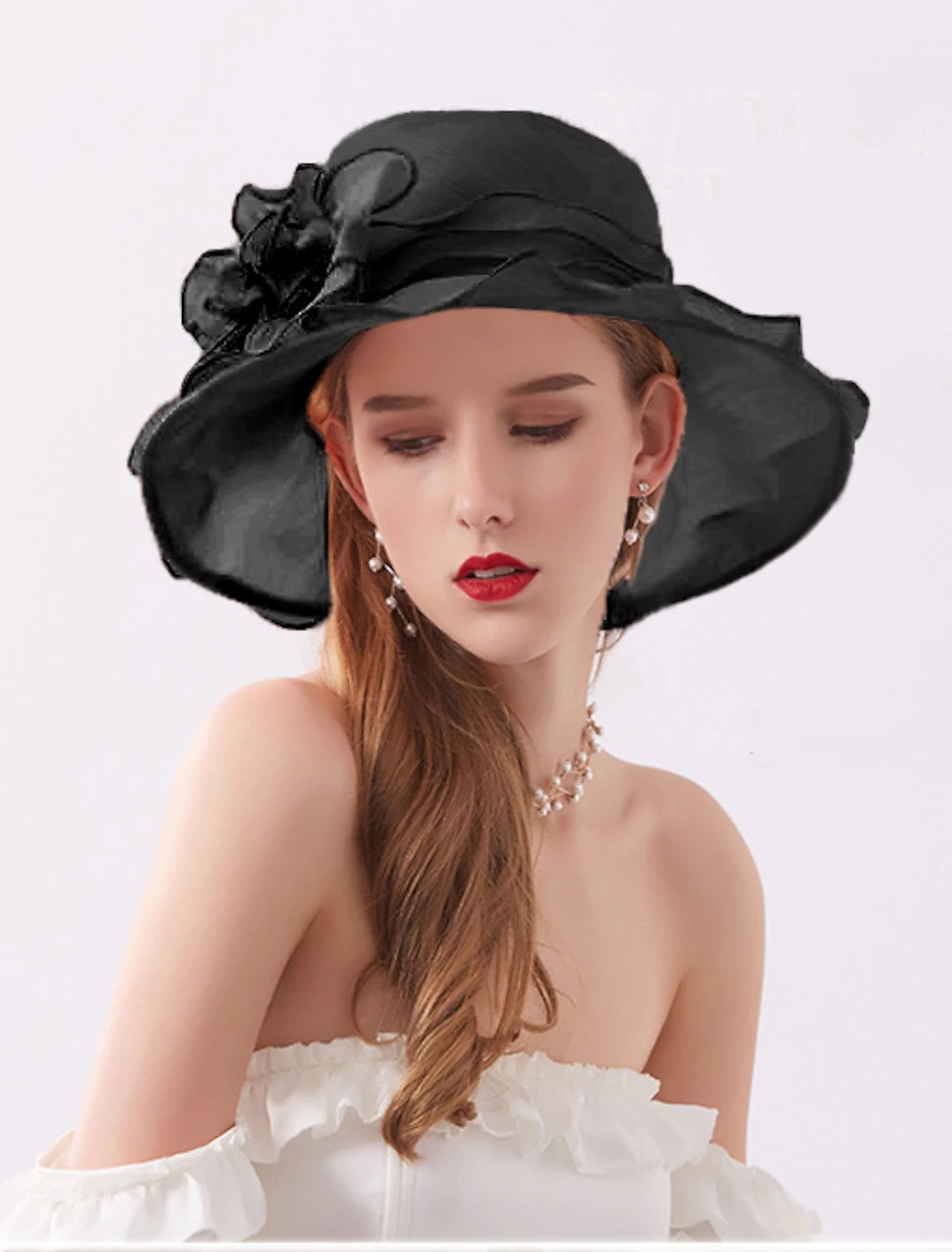 Close-up of the floral appliques on a white organza sun hat.