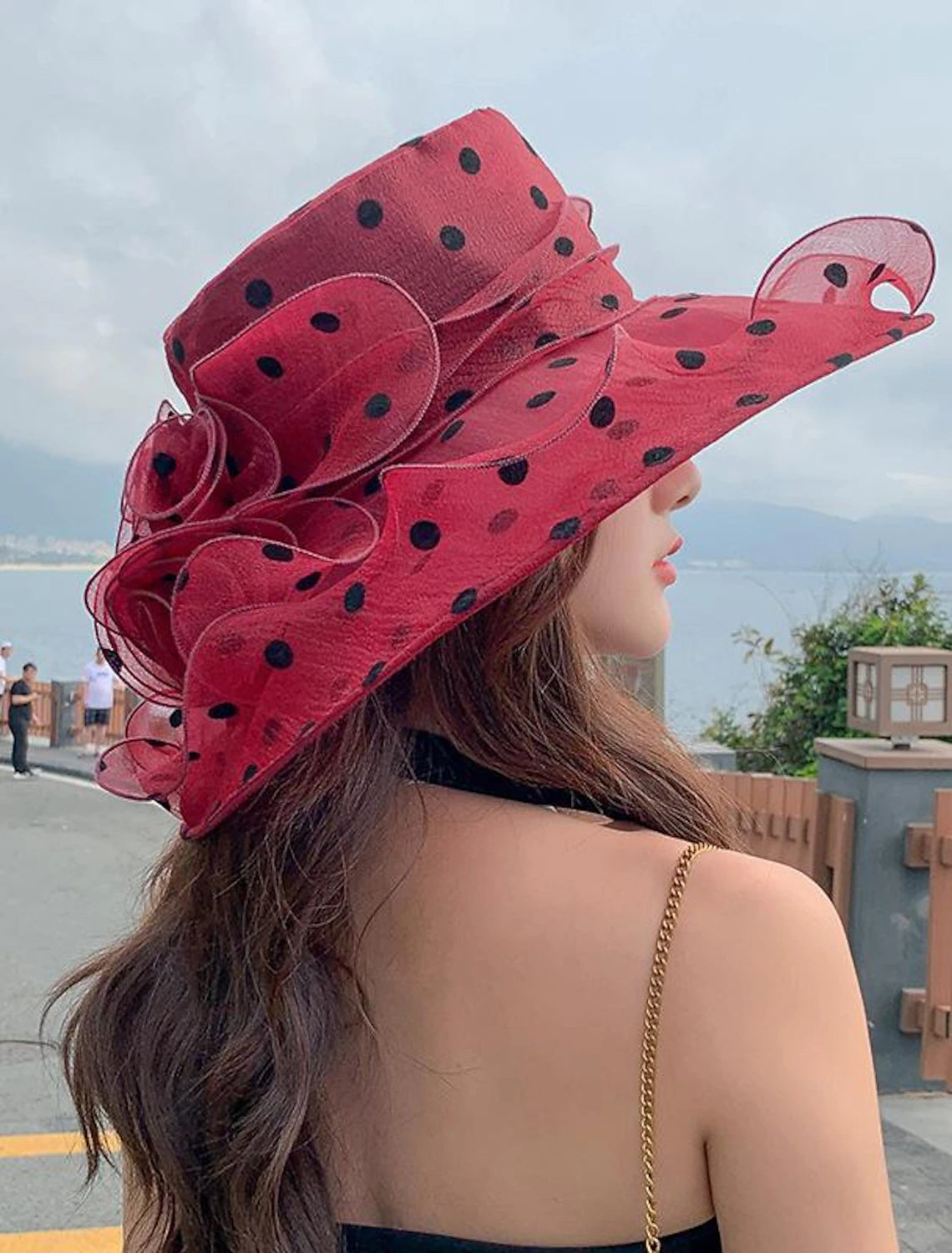 Close-up of delicate floral appliques on a sheer tulle sun hat.