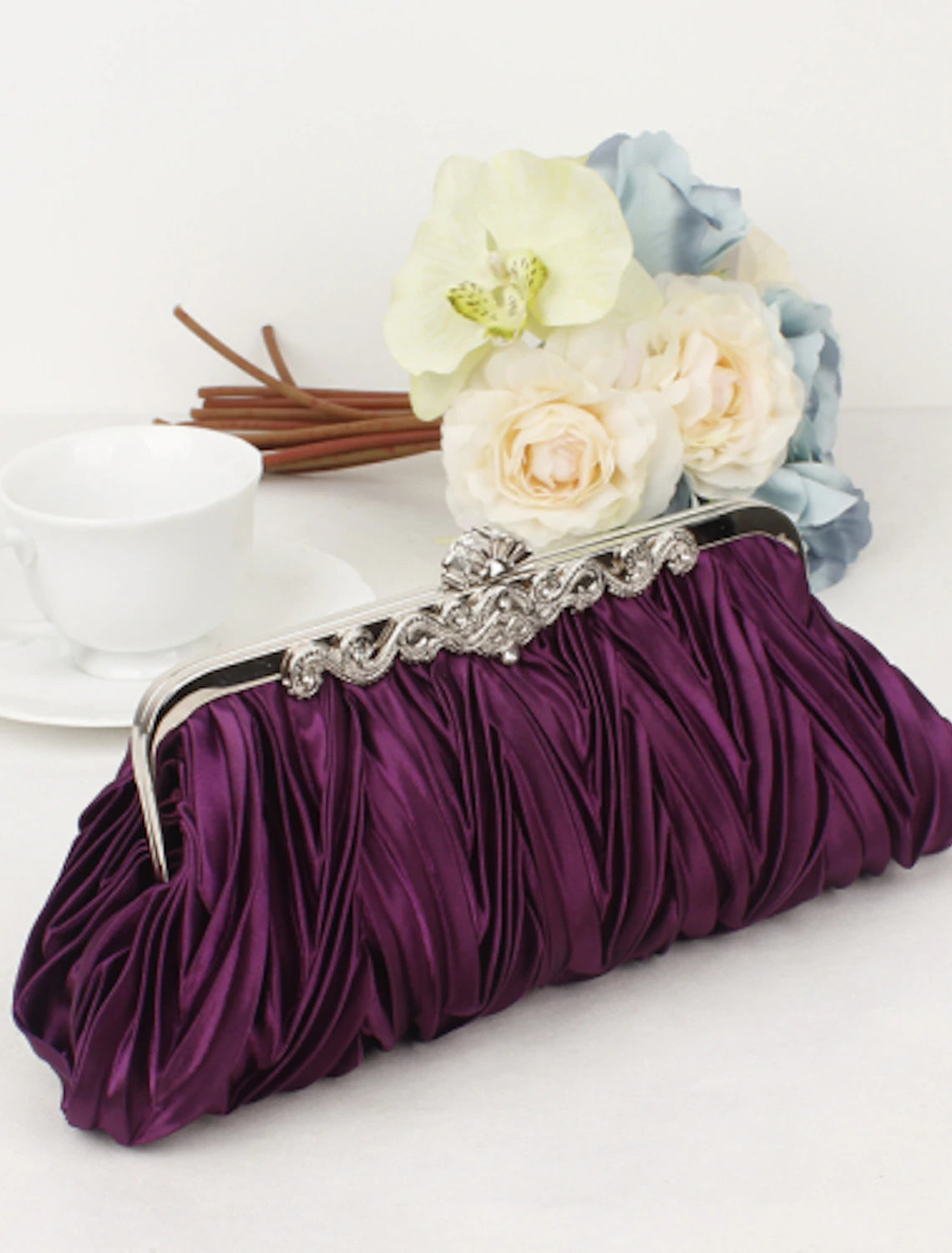 Clutch bag with metal frame and intricate rhinestone details.
